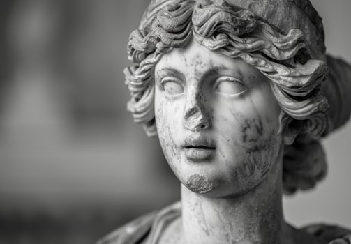 Weathered stone statue of a classical figure photo