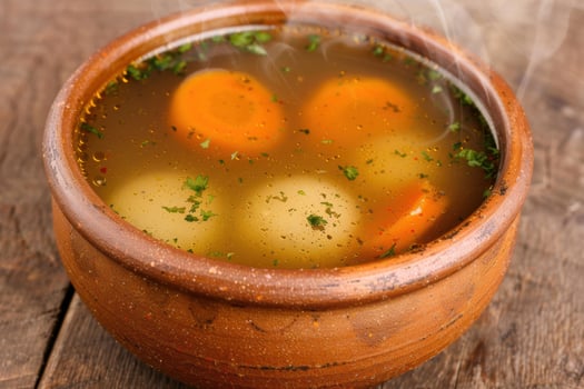 Hearty vegetable soup in a rustic ceramic bowl photo