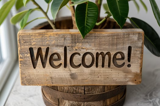 Rustic wooden welcome sign with green leaves photo
