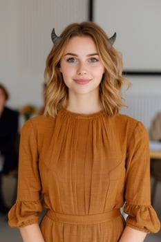 young woman with horns in mustard yellow dress photo