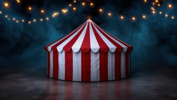 Illuminated circus tent against a dark night sky photo
