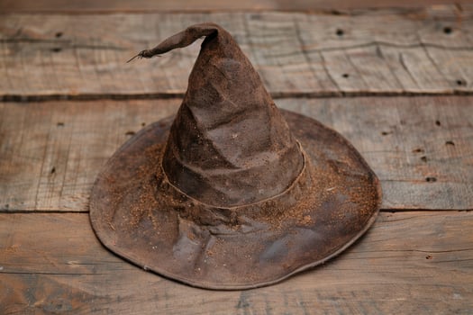 old witch hat on wooden background photo