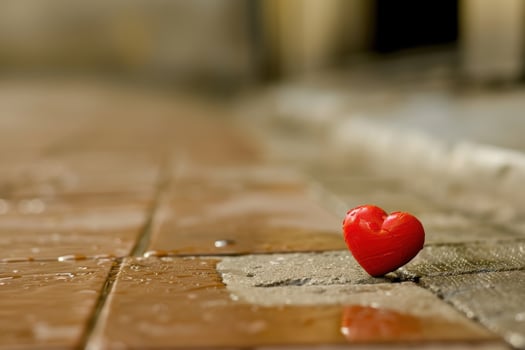 red heart shaped object on wooden surface photo