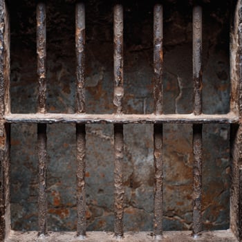 Rusty metal bars in a dark, grungy setting photo