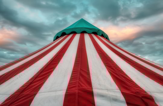 Vibrant circus tent against dramatic sky photo