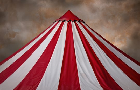 Colorful circus tent against cloudy sky photo