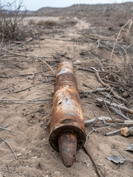 Rusted metal pipe in desert landscape photo