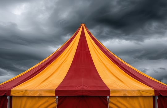 Vibrant circus tent against stormy sky photo
