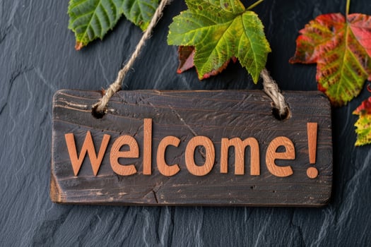 Autumn leaves and welcome sign on wooden board photo