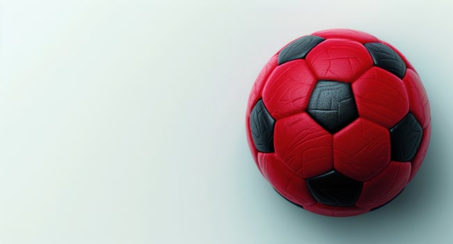 red and black soccer ball on white background photo