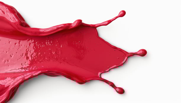 Vibrant red paint splash on white background photo
