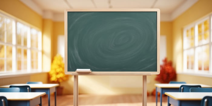 A classroom with a blackboard and chairs photo