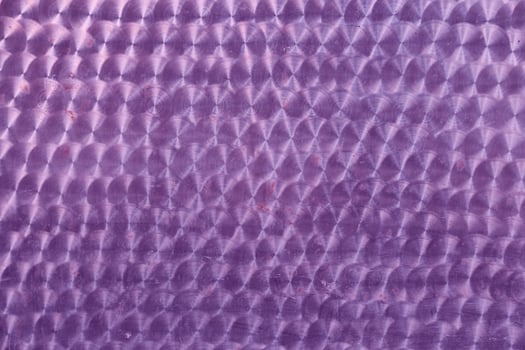 A holographic surface of lilac color with space for copying. Iridescent film texture photo