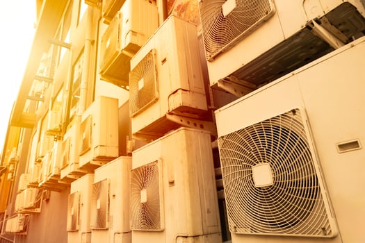 Many Air conditioner outside cooling unit office building in hot weather from global warming crisis environment impact. photo