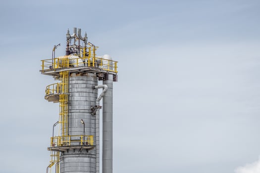 Oil petroleum refinery plant building distillation columns tower, Closeup part of fuel gas pipe complex, Crude oil petrochemical industrial building. photo