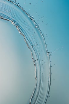 Water droplets splash on blue background. photo