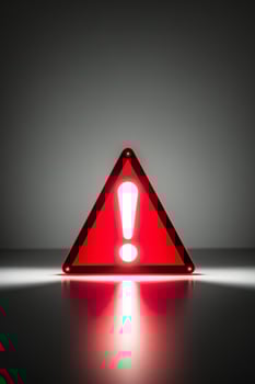 glowing neon red triangle sign with exclamation point on dark warning indicator alert signal. photo