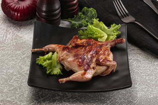 Grilled quail in the plate photo