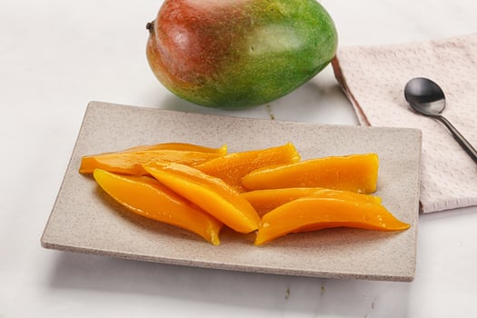 Canned mango slices in the bowl photo