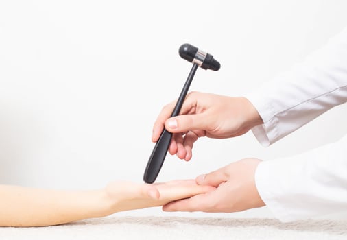 The doctor checks the palmar chin reflex in the palm of the patient. Verification and treatment of vegetative vascular dystonia and Parkinson's disease, copy space photo