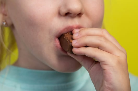 A seven year old little caucasian girl's dirty mouth from eating a candy bar. Diabetes mellitus and glucose. photo