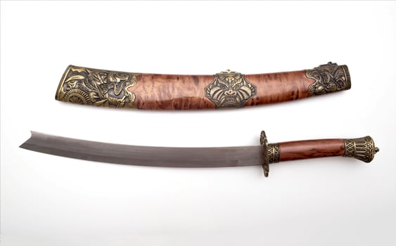 Katana saber with beautiful patterns on a white background, isolate. Close-up photo