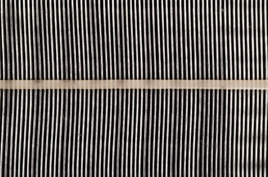 Dirty car air filter texture and background. Air filter element in a car engine, macro, damaged photo