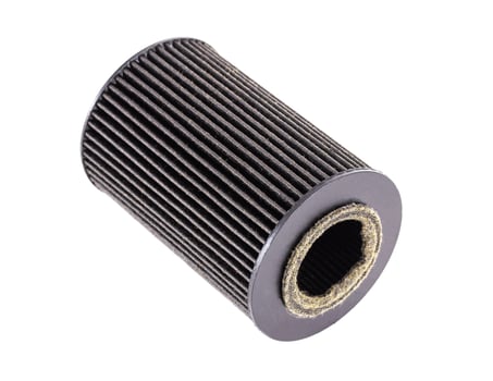 Car oil filter insert on white background, isolate. The concept of cleaning oil from dirt and impurities. Close-up photo
