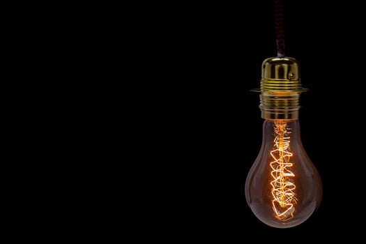 Vintage Edison Light Bulb with Glowing Filament. Copyspace photo