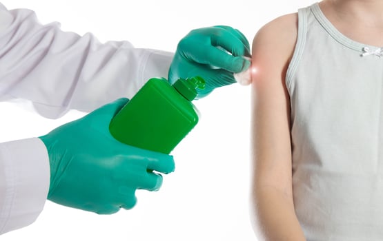 Doctor's hands with cotton wool and antiseptic treating the skin before vaccination against tetanus and viral hepatitis. Revaccination of children, hemophilus influenzae infection photo