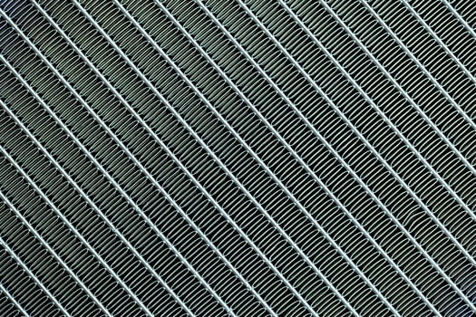 Texture of a honeycomb of an automotive aluminum car cooling radiator, close-up. photo
