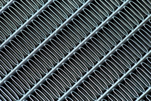 Texture of a honeycomb of an automotive aluminum car cooling radiator, close-up. photo