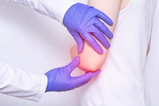 Girl patient at the doctor's medical examination, pain and inflammation in the elbow joint, close-up, Epicondylitis photo