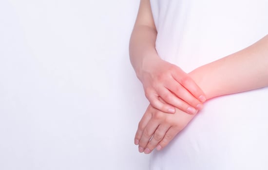 Pain and inflammation in the hand on the wrist of a girl, carpus, tendonitis and podagra, white background, copy space photo