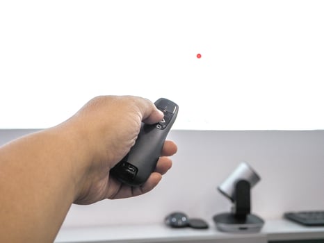 Close up hand holding a remote control slide presentation photo
