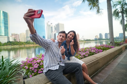 A man and woman taking a selfie photo