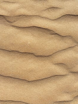 top view sand dunes with ripple texture background for desert themes photo