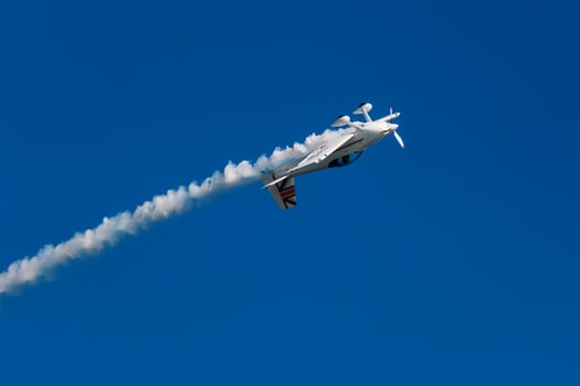 Stunt aerobatic plane performing stunts in air photo