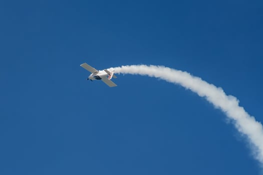 Stunt aerobatic plane performing stunts in air photo