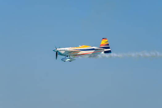 Stunt aerobatic plane performing stunts in air photo