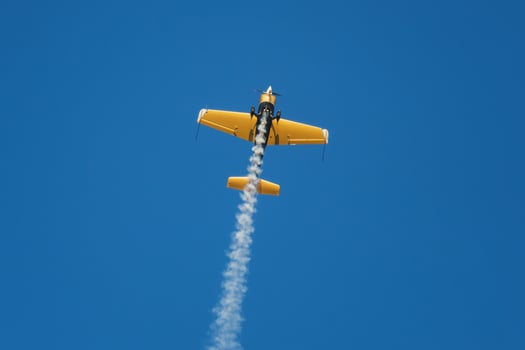 Stunt aerobatic plane performing stunts in air photo