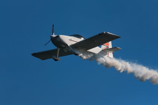 Stunt aerobatic plane performing stunts in air photo