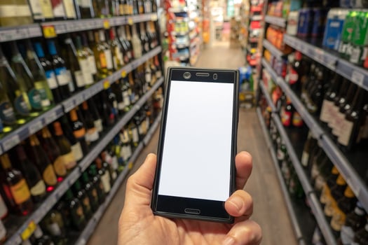 White smartphone screen for shopping app in woman's hand. photo