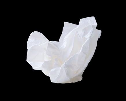 Side view of screwed or crumpled white tissue paper ball isolated on black background with clipping path photo