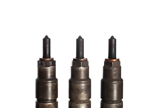 Needles and nozzles on nozzles from a diesel engine. Deterioration of the fuel system of the car, macro. White background, isolate photo