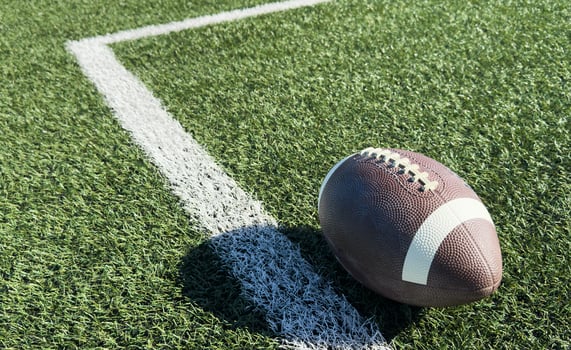 Rugby ball on green field photo