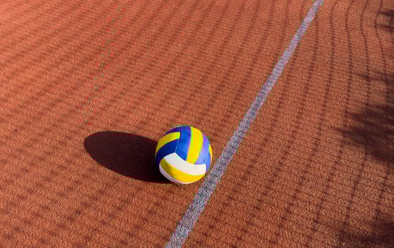volleyball. blue with yellow color ball on the playground. volleyball cover, red. ball game photo