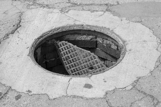 Outdoor sewer hatch, close up, broken and open sewer cover photo