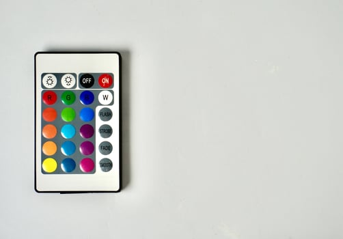 RGB lamp wireless remote control with colorful buttons isolated on horizontal ratio copy spaced white background. photo