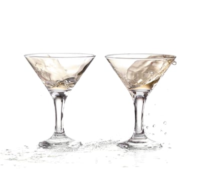 two wine swirling in a goblet martini glass, isolated on a white background photo